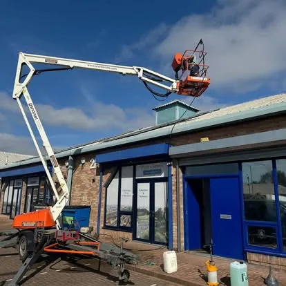 Second view of high-access exterior work at a commercial unit