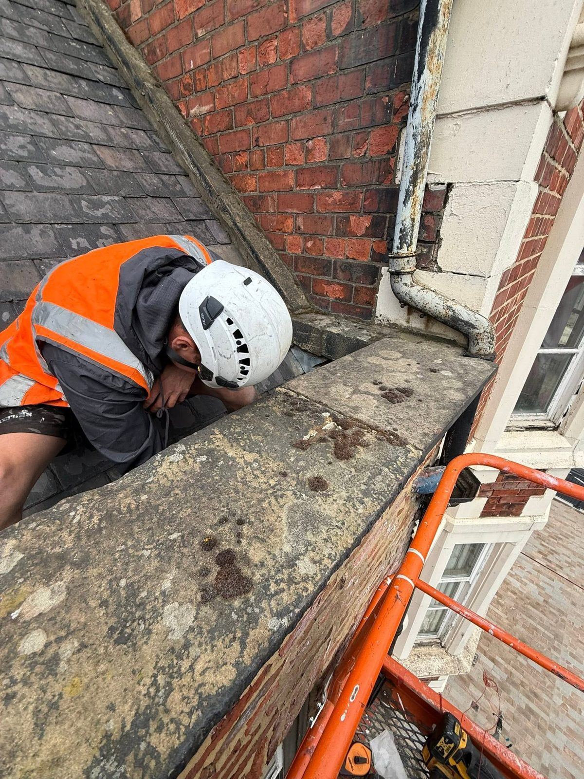 IGM operative in hi-vis and helmet working at height on a commercial building in Stockton-on-Tees