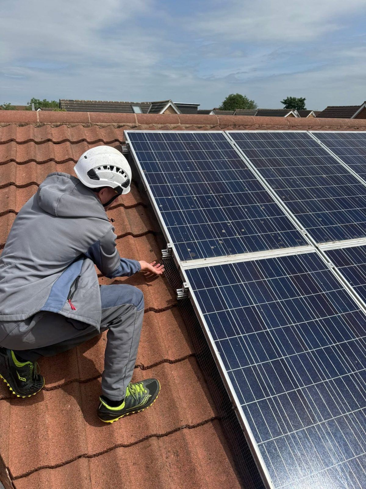 IGM operative inspecting solar panels on a tiled roof in Teesside